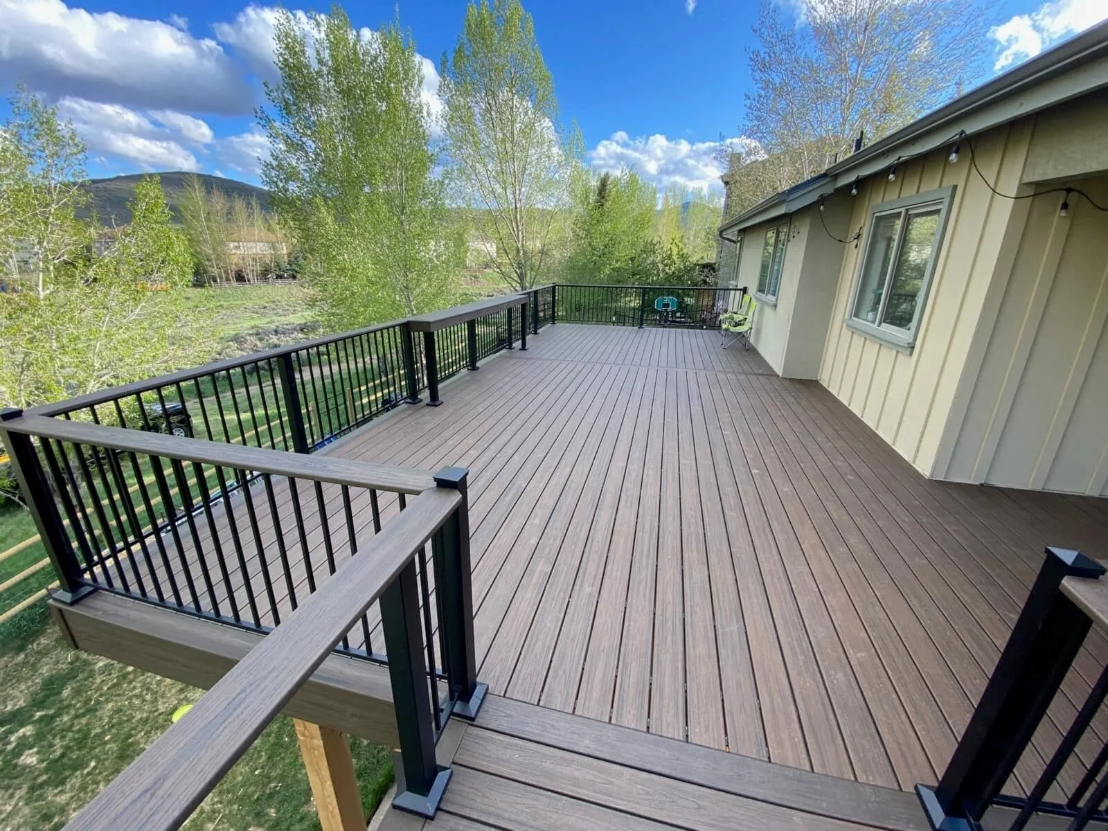 Long composite deck beside a home