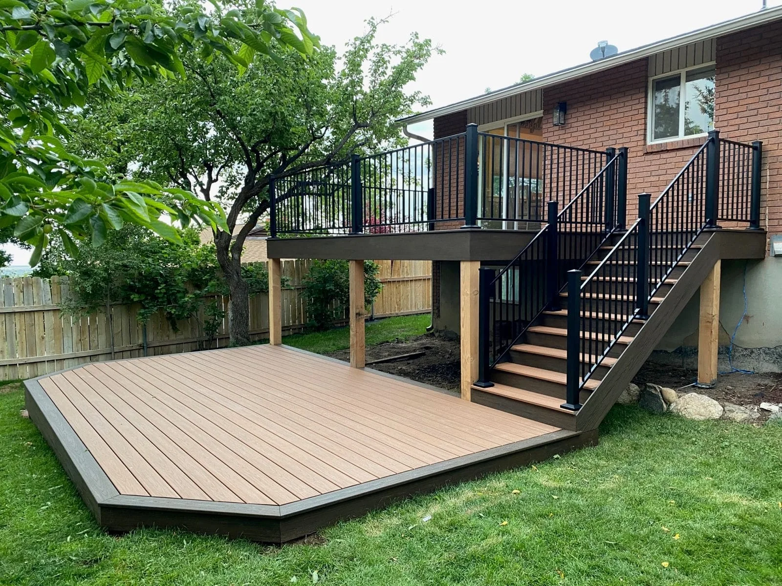 Two-level composite deck with stairs