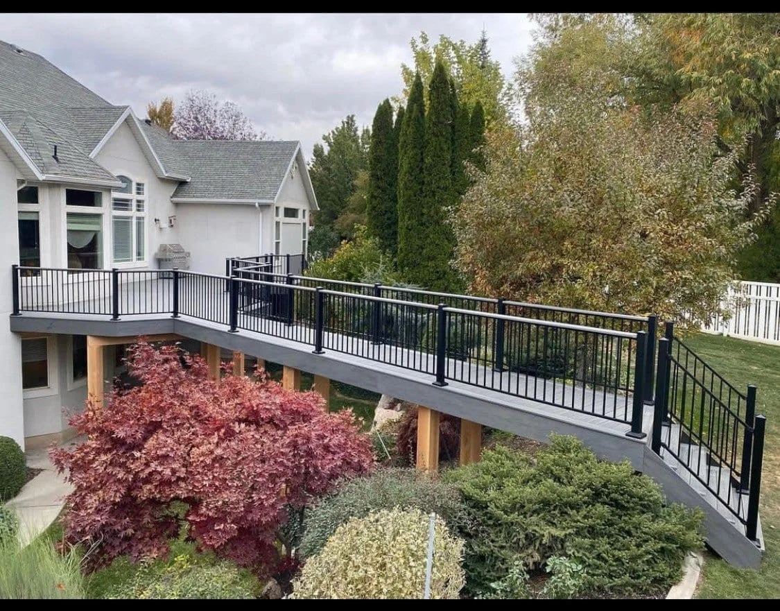 Composite deck with wraparound railing